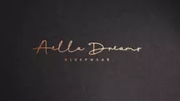 aella dreams logo mockup with the graphic reproduced in gold foil and debossed into dark coloured paper board