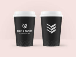 takeaway coffee cup featuring the locks logo, along with a pattern system made up of the symbol