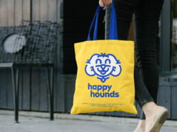 cropped image showing the bright yellow happy hounds tote bag