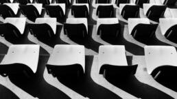 A black and white photo of empty auditorium seats