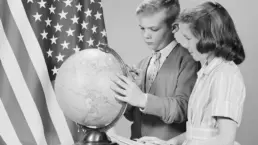 vintage photo of two school children looking at a globe