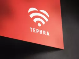 tephra logo design printed in white onto red board