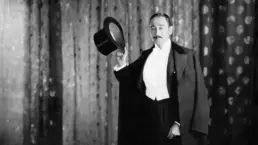 a vintage magician poses in black and white