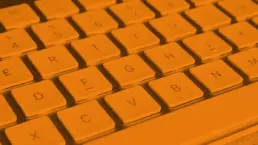 close up of a mac keyboard in orange