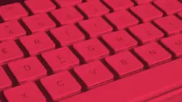 close up of a mac keyboard in pink