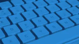 close up of a mac keyboard in blue